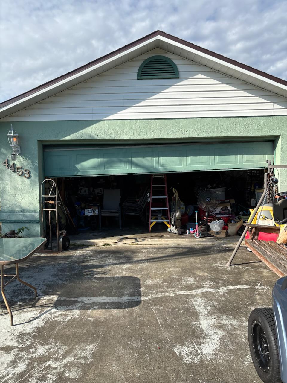 Green garage door exterior with customer